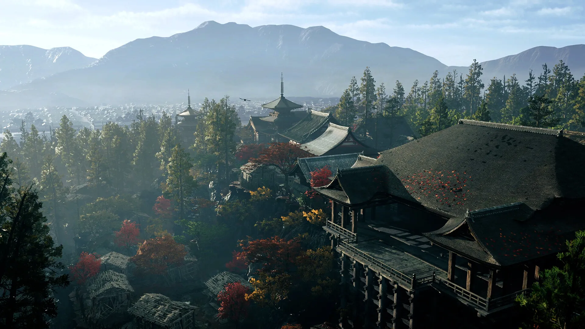 A wooden temple complex on forested hills above Kyoto in autumn