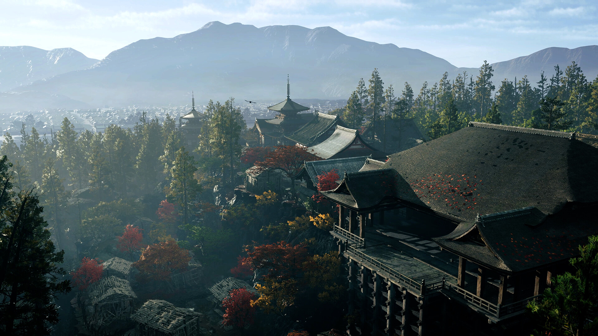 A wooden temple complex on forested hills above Kyoto in autumn